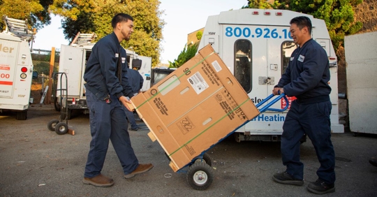 Technicians getting ready to install an air conditioner
