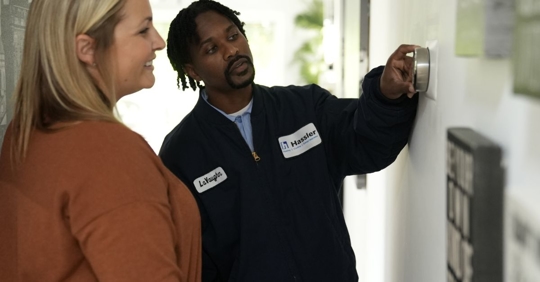 HVAC technician helping customer