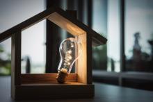 light bulb with model house, home electricity concept