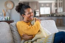 woman comfortable under blanket at home