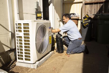 Hassler Employee installing Heat Pump