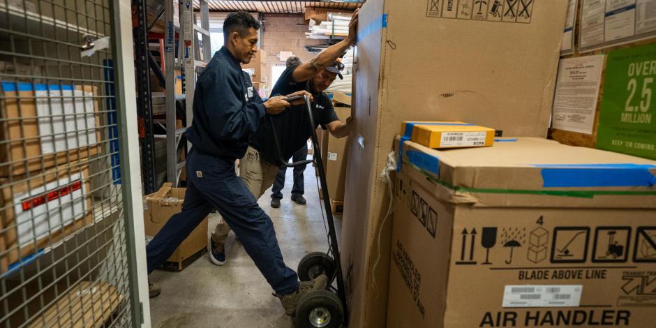 Hassler warehouse men moving boxes